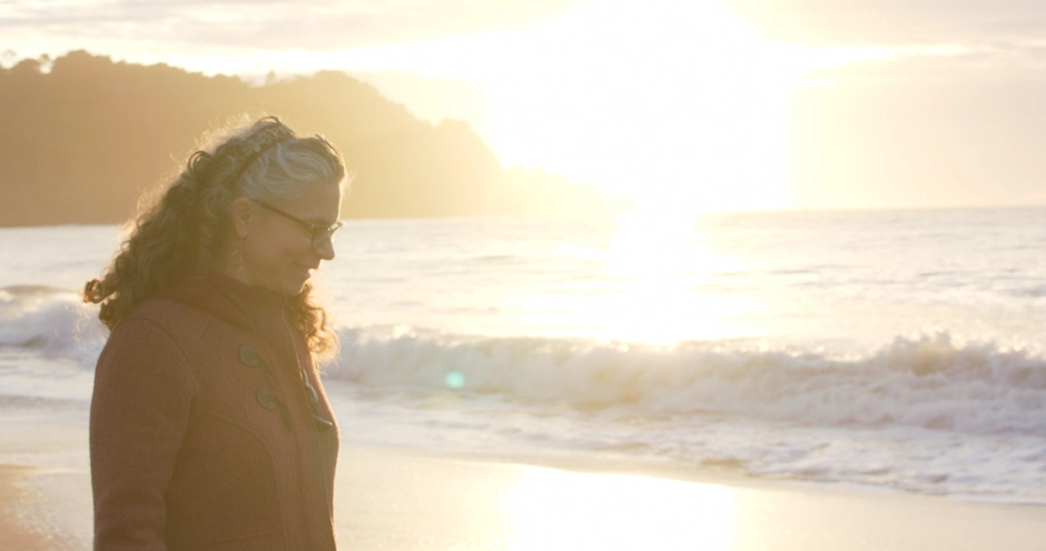 Interviewee walkling along the beach