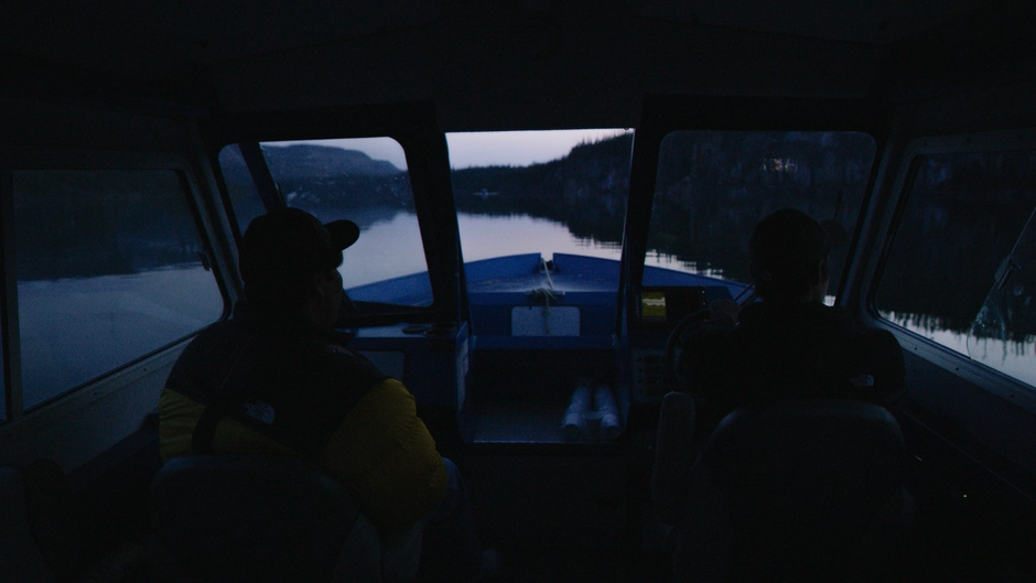 Two guardians sit in the boat at dusk