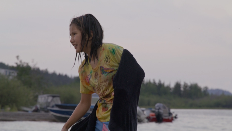 A dene girl plays near the lake