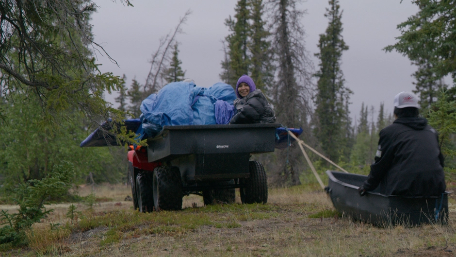 Kids sit in the back of an ATV